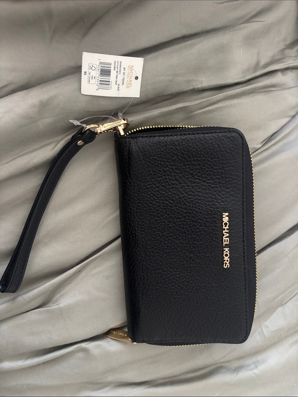 Michael Kors Black and Gold Jet Set Travel Phone Case Tag